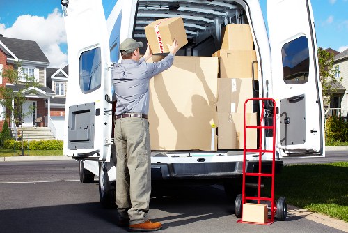 Local moving van loading furniture near Gidea Park homes