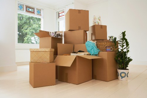 Professional movers handling furniture and packing materials