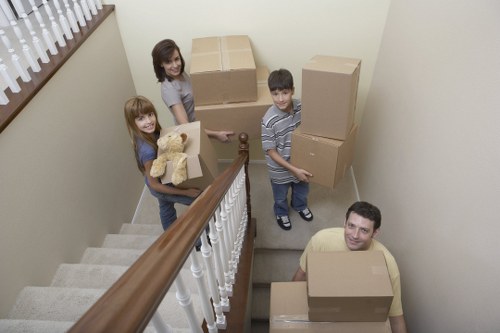 Professional movers loading household items into a removal van